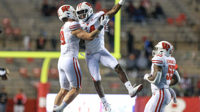 Nov 6, 2021; Piscataway, New Jersey, USA; Wisconsin Badgers linebacker Jordan Turner (54) celebrates his interception with linebacker Nick Herbig (19) and linebacker Maema Njongmeta (55) during the second half against the Rutgers Scarlet Knights at SHI Stadium. Mandatory Credit: Vincent Carchietta-USA TODAY Sports